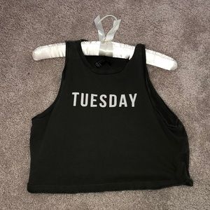 green tank top with “tuesday ” written on it